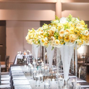 Yellow floral on white bell vases with hanging crystals. Centerpieces for estate table. Decor and floral by Southern Event Planners. Photo by 3eightphotography