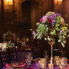Tall floral centerpieces with purple hues and greenery.   Photo by Snap Happy Floral and décor by Southern Event Planners